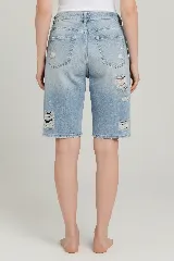 Bermuda de denim azul claro con efecto desgastado y roturas, de tiro medio y calce relajado.