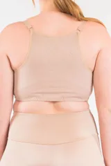 Top corrector de postura color piel, con breteles elásticos regulables, copas moldeadas en lycra y prendido frontal con ganchos.