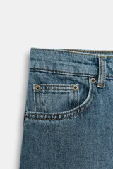 Bermuda larga de jean color azul, tiro medio, con diseño wide leg y bolsillos. Cuenta con bajo desflecado y cierre frontal con cremallera y botón metálico.