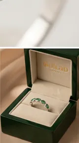 Anillo de plata 925 con diseño de medio sin fin, engastado con piedras naturales de esmeralda en corte ovalado.