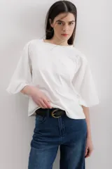 Blusa blanca de algodón con mangas abullonadas con bordado calado.