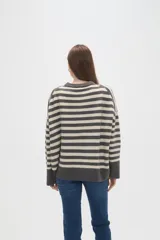 Sweater de tejido de punto con diseño de rayas horizontales en color rojo y azul marino, cuello redondo a la base y mangas largas con corte holgado.