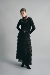 Remera de manga larga y calce relajado, confeccionada en algodón negro. Presenta un escote redondo y un bordado decorativo de piedras en el pecho con la frase 'Mon Amour'.