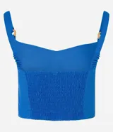Blusa cropped de viscolino azul con escote en V, breteles con adornos y lastex en la espalda.