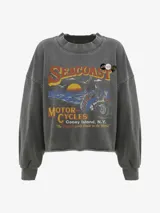 Buzo de algodón gris oscuro con lavado suave, cuello redondo y puños acanalados. Presenta un estampado vintage de estilo retro con temática de motocicletas, el texto "SEACOAST MOTOR CYCLES Coney Island, N.Y. 'The Biggest Little Dealer in the World'" y un diseño gráfico de una persona en moto al atardecer. Tiene tres pines decorativos prendidos en la zona del cuello.