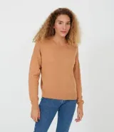 Buzo de punto color tostado, con cuello redondo, manga larga y sisa desplazada.