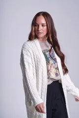 Cárdigan negro tejido con diseño de ochos, corte holgado y bolsillos frontales.