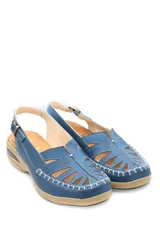 Sandalias bajas color beige con recortes geométricos en la capellada, tira trasera con hebilla ajustable y suela con cámara de aire.