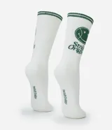 Medias de caña larga color blanco con detalles en verde, que incluyen un estampado de carita sonriente y el texto 'Smile Origins' en el lateral. Cuentan con franjas verdes en el borde superior.