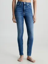 Jeans ajustados de tiro alto para mujer, en denim de algodón elástico con lavado azul medio vintage. Presentan diseño de cinco bolsillos y bragueta con cremallera.