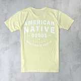 Remera color amarillo claro de algodón con estampa frontal en blanco con el texto "American Native Goods. Proudly made by Dixon Co.".