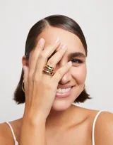Anillo dorado de metal bañado en plata con diseño orgánico irregular.