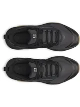 Championes de entrenamiento Under Armour Charged Commit TR 5, color negro con detalles en color tostado en la suela y entresuela, y la marca visible en el lateral. Confeccionados con malla transpirable y revestimientos de cuero.