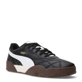 Championes urbanos Puma modelo Tifosi, color negro con detalles en blanco y suela de goma marrón. Presentan un diseño con costuras acolchadas en la puntera y el logo de la marca en dorado en el lateral.