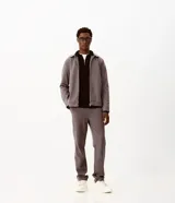 Pantalón slim de sarga color gris, con cintura con pasacintos, cierre de botón y cremallera, bolsillos laterales y bolsillos traseros embutidos.