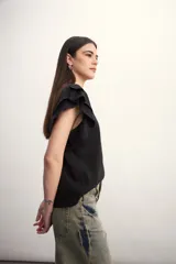 Remera color amarillo pastel con cuello redondo y mangas cortas con volados.