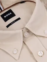 Camisa de corte slim fit en tejido oxford color beige, con cuello abotonado y logo bordado en el pecho.