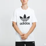 Remera blanca de algodón con logo Adidas Trefoil estampado en negro en el frente.