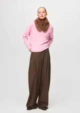 Jersey de punto trenzado color rosado, con cuello redondo y mangas largas de corte recto.