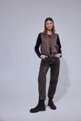 Blusa de diseño combinado con frente de lino en color marrón y espalda y mangas de algodón con spandex en color negro. Presenta un cuello redondo con detalle de mini volado frontal y cierre de botones oculto.