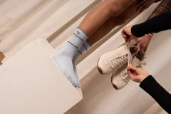 Medias celestes de caña alta con diseño acanalado, terminaciones con volados en hilo oscuro y bordado decorativo en el lateral superior.