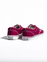 Championes de lona color azul grisáceo, estilo skate o casual, con cordones blancos y suela de goma blanca con una línea fina azul en el borde.