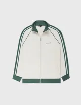 Campera deportiva de tejido doble faz color blanco roto, con cuello, puños y cintura en verde oscuro. Presenta mangas raglán con doble franja verde oscuro y blanco, cierre frontal y logo bordado en el pecho.