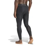 Calza de compresión deportiva Adidas modelo Techfit, color negro. Presenta cintura elástica con el logo de la marca y la inscripción Techfit, y logo de Adidas en la parte inferior de la pierna. Diseñada con tecnología Aeroready y bolsa esculpida en 3D para mayor soporte y comodidad.