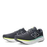 Championes de running New Balance Evoz con tecnología Fresh Foam en la entresuela. Presentan un diseño en color gris oscuro con detalles en verde neón y blanco, confeccionados en malla transpirable con el logo N característico en los laterales.