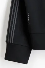 Campera deportiva negra de tejido funcional efecto neopreno con tecnología DryMove. Presenta cuello elevado, cierre bidireccional, bolsillos laterales y franjas grises en las mangas.