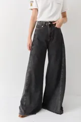 Pantalón de jean azul de tiro alto y corte wide leg súper amplio, con diseño de perneras ancha y terminación desmechada en el ruedo.