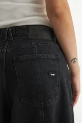 Pantalón jean negro de pierna ancha, corte holgado y tiro medio.