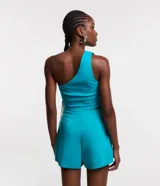 Blusa cropped roja de tejido bengalina, con escote asimétrico de un solo hombro y cierre de cremallera lateral.