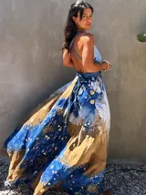 Vestido largo verde con diseño estampado tipo tie-dye y detalles dorados, de corte fluido, un solo hombro y diseño amplio.