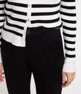 Pantalón de jean modelo mom con trabillas en la cintura, pliegues, cierre delantero tradicional y bajo plegado.