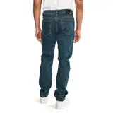 Pantalón de jean de corte slim, color azul oscuro, con cinco bolsillos y logo de CAT en la parte trasera.