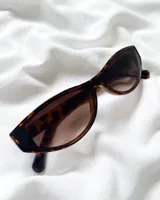Lentes de sol con montura de carey y lentes marrones.