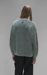 Sweater de cuello redondo con diseño de tejido texturizado en color verde y blanco. Presenta un calce relajado y terminaciones en punto rib en el cuello.
