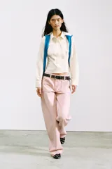 Pantalón jeans de tiro medio, corte ancho (loose), color rosa pálido. Presenta bolsillos plastrón tanto en el frente como en la espalda.