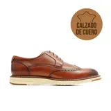 Zapatos de vestir Hanker de cuero marrón con diseño tipo brogue y suela blanca dentada.