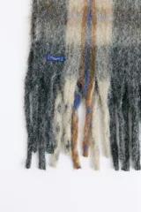 Bufanda de estilo escocés con textura suave, diseño a cuadros en tonos azul y verde, con flecos en los extremos.