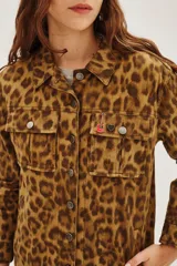 Campera de canvas con estampado animal print de leopardo, corte recto, cuello camisero, cierre frontal con botones metálicos y bolsillos frontales con solapa.