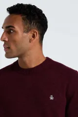 Sweater de punto color bordó con cuello redondo, mangas largas y puños acanalados. Presenta el logo de la marca bordado en el pecho.