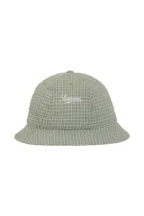 Gorro tipo bucket de la marca Supreme, confeccionado en tela con estampado de cuadros vichy en tonos verde y blanco. Presenta el logo de la marca bordado en la parte frontal y ojales de ventilación.