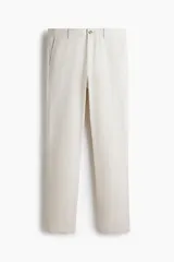 Pantalón chino de sarga elástica de algodón, con cierre de cremallera y botón, bolsillos laterales al bies y bolsillos traseros con botón. Presenta un corte ajustado que define la silueta.