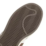 Championes Adidas modelo Campus 00s, color marrón con las icónicas tres tiras laterales en blanco. Presentan un diseño de inspiración retro con capellada de gamuza, cordones anchos y suela de goma en tono crema.