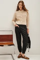 Pantalon cargo de corte recto y acabado satinado, color negro, con bolsillos laterales tipo cargo y puños elásticos en los tobillos.