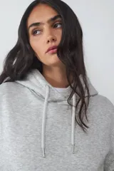 Buzo con capucha ajustable mediante cordón y bolsillo tipo canguro. Presenta mangas largas, puños y ruedo acanalados.