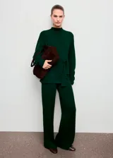 Pantalón de punto color verde oscuro, de tiro medio, diseño recto y largo, con cintura elástica y detalle de costuras.