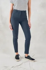 Pantalón de vestir azul marino, de corte skinny y tiro medio, con bolsillos laterales y cierre invisible en el lateral.